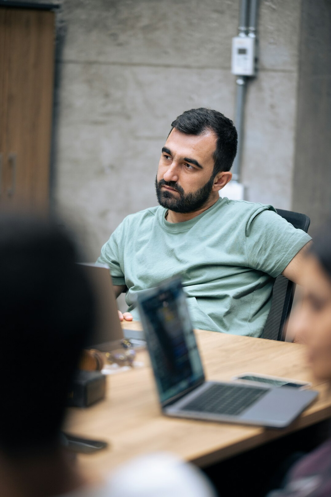man listening in meeting